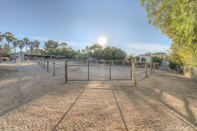 view of gate with a rural view