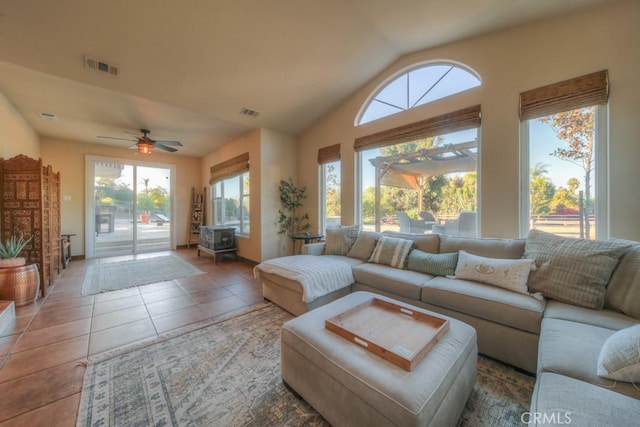 living room featuring ceiling fan, tile patterned flooring, and a wealth of natural light