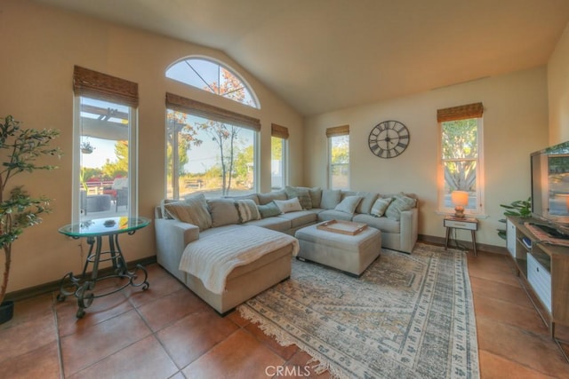 tiled living room with vaulted ceiling and a wealth of natural light