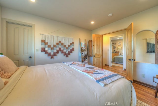 bedroom featuring light hardwood / wood-style floors and a closet