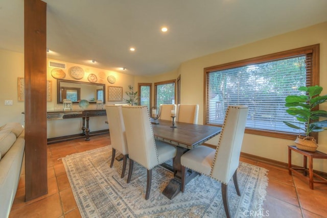 dining space featuring light tile patterned flooring