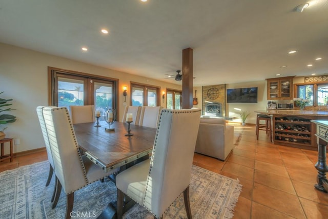 tiled dining space featuring ceiling fan and plenty of natural light