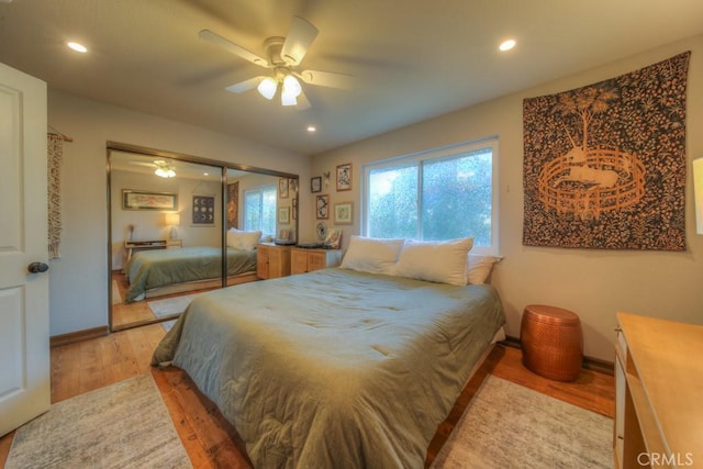 bedroom featuring ceiling fan, hardwood / wood-style floors, and a closet