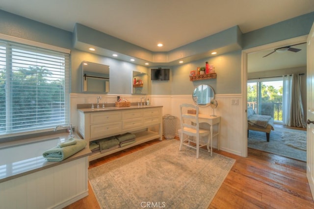 bathroom featuring ceiling fan, vanity, and wood-type flooring