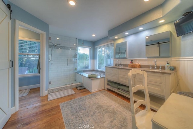 bathroom featuring vanity, plus walk in shower, and hardwood / wood-style floors