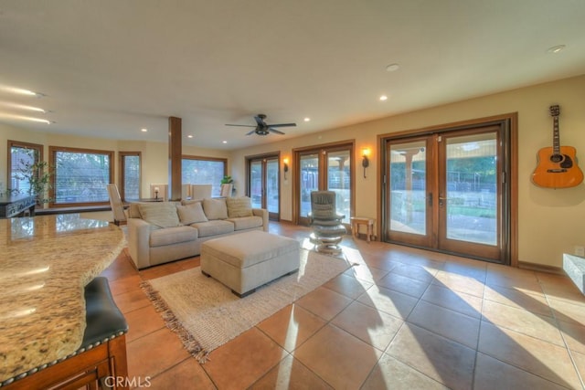 living room with ceiling fan, french doors, and light tile patterned floors