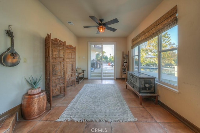 entryway with ceiling fan and light tile patterned floors