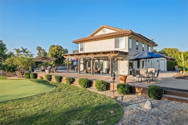 rear view of house featuring a patio area and a pergola