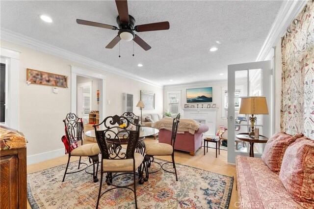 dining room with ceiling fan, ornamental molding, and a textured ceiling