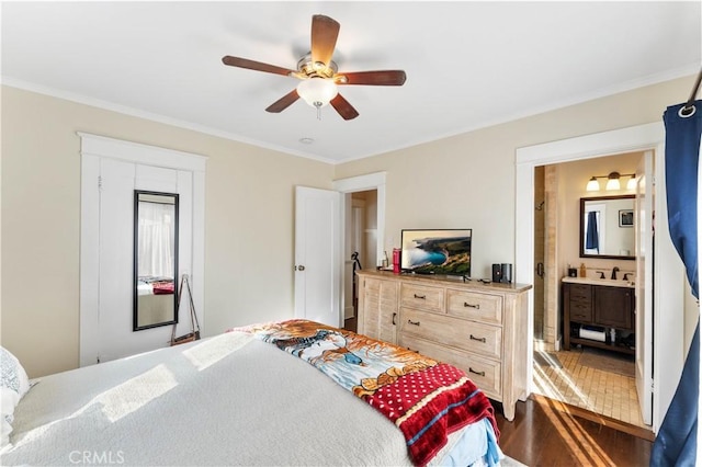 bedroom with ceiling fan, ensuite bath, and crown molding