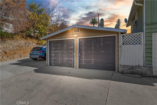 view of garage at dusk