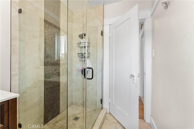 bathroom with tile patterned floors and a shower with door