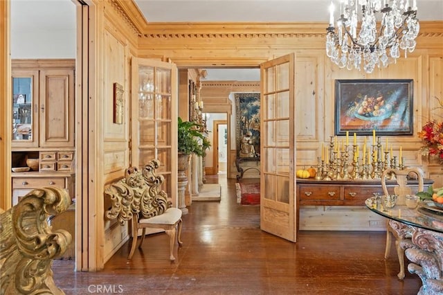 hallway with crown molding, dark hardwood / wood-style floors, and an inviting chandelier