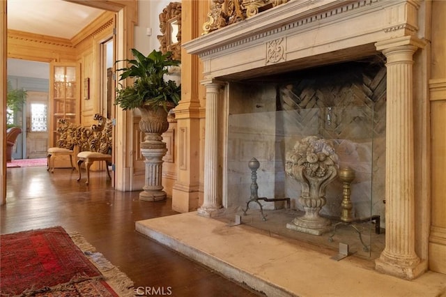 interior details with decorative columns and hardwood / wood-style flooring