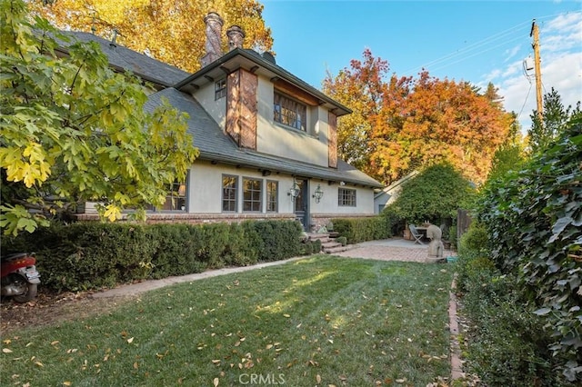 view of front of property with a patio area and a front yard