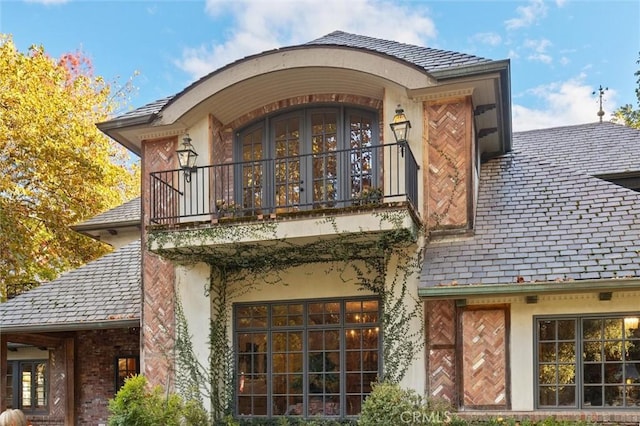 back of house featuring a balcony