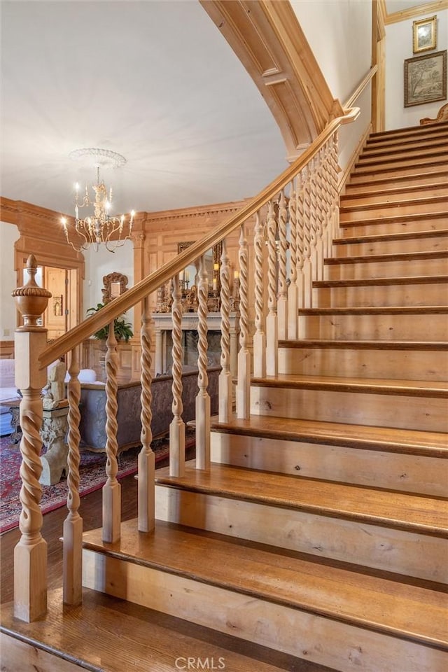 stairs featuring an inviting chandelier