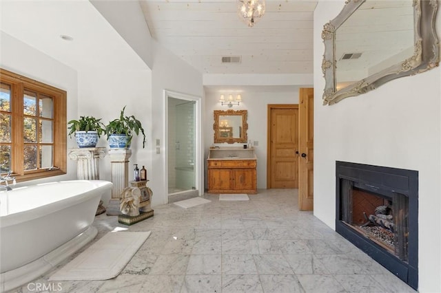 bathroom featuring separate shower and tub and vanity