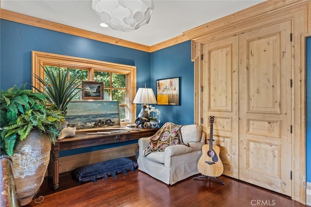 sitting room featuring dark hardwood / wood-style flooring and ornamental molding