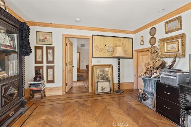 sitting room featuring ornamental molding and parquet flooring