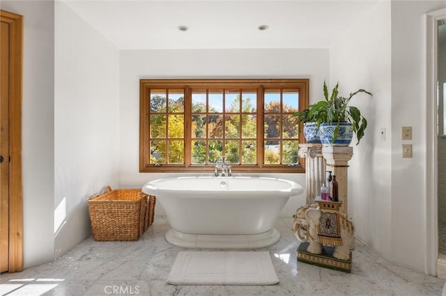 bathroom featuring a tub to relax in