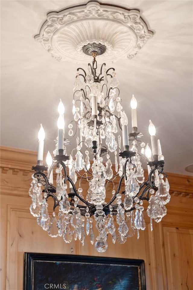 interior details featuring an inviting chandelier