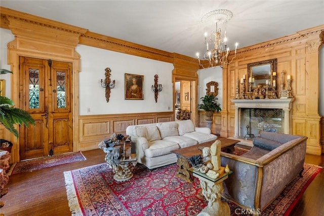 living room with ornamental molding, dark hardwood / wood-style floors, and a notable chandelier