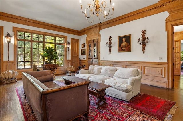 living room featuring a chandelier, dark hardwood / wood-style floors, and ornamental molding