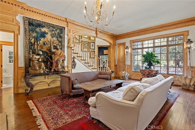 living room featuring a chandelier, dark hardwood / wood-style floors, and ornamental molding