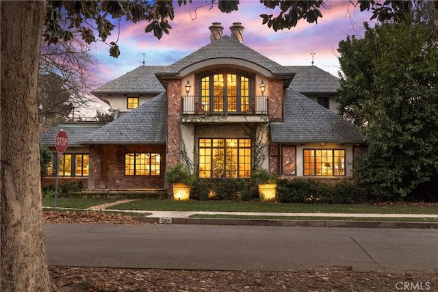 french provincial home with a balcony