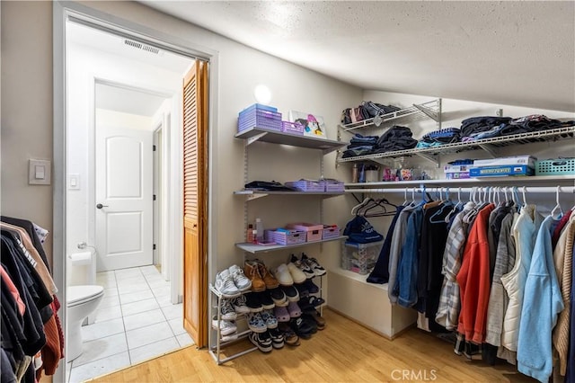 walk in closet featuring light hardwood / wood-style floors