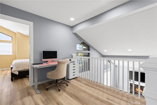 office featuring light hardwood / wood-style floors and vaulted ceiling with beams