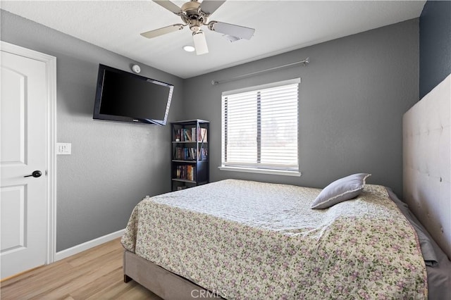 bedroom with ceiling fan and light wood-type flooring