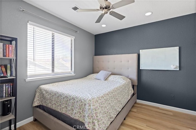 bedroom featuring ceiling fan and light hardwood / wood-style flooring