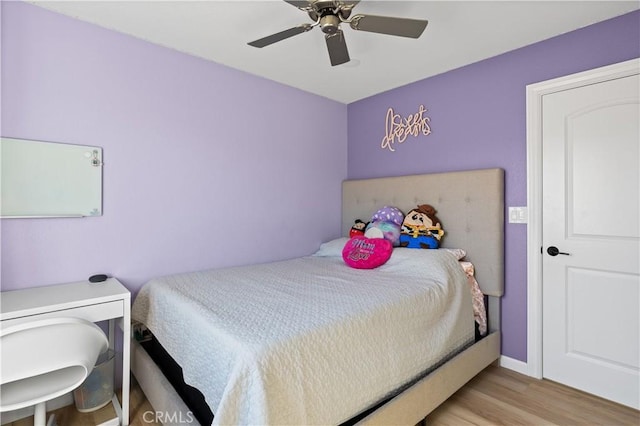 bedroom with ceiling fan and light wood-type flooring