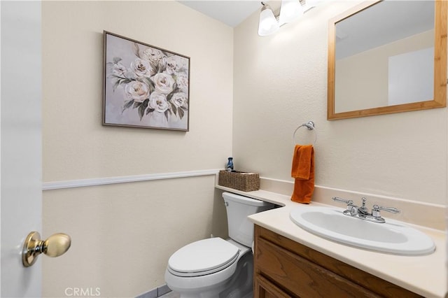 bathroom featuring toilet and vanity