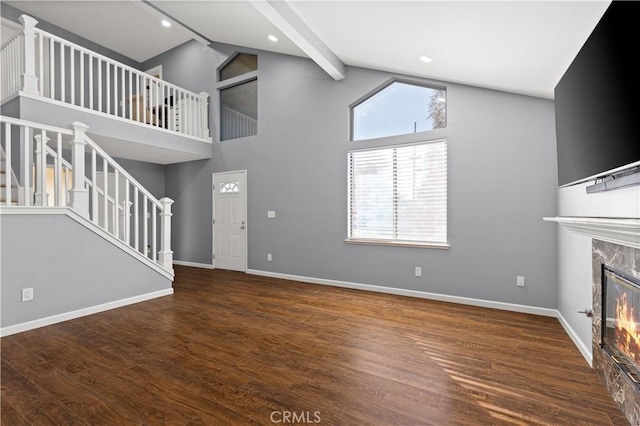 unfurnished living room with high vaulted ceiling, dark wood-type flooring, beamed ceiling, and a fireplace