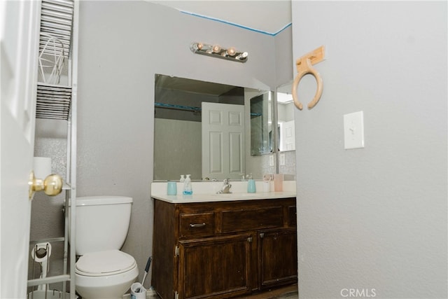 bathroom featuring toilet and vanity