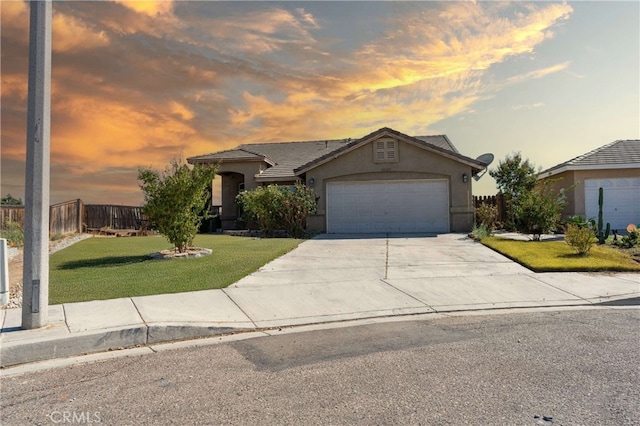 view of front facade with a garage and a yard