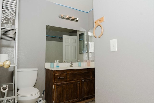 bathroom featuring toilet and vanity