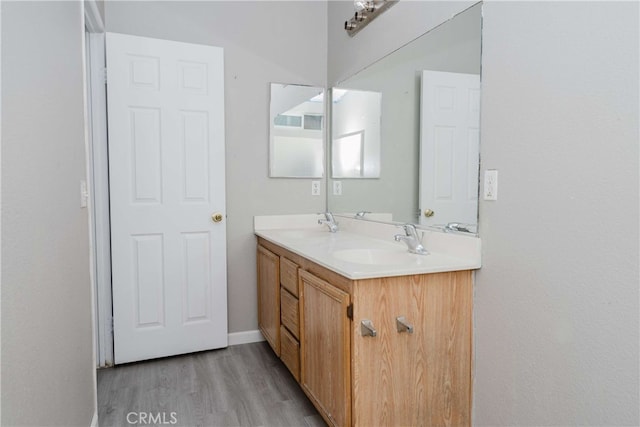 bathroom featuring hardwood / wood-style floors and vanity