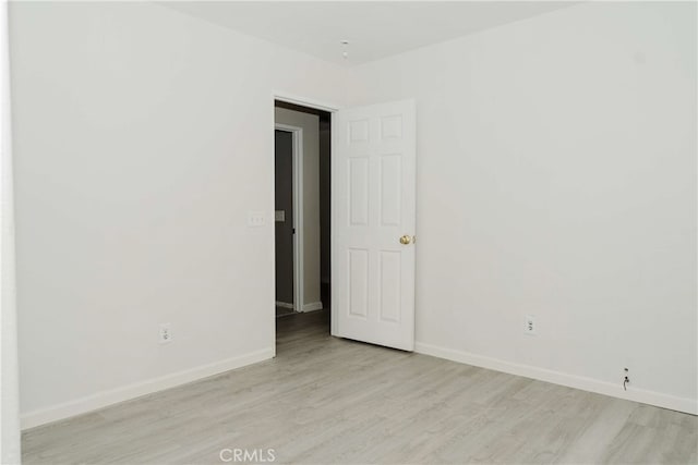 spare room featuring light hardwood / wood-style flooring