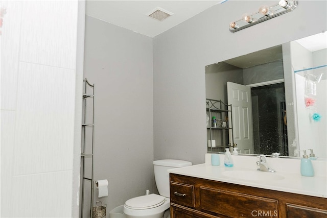 bathroom featuring toilet and vanity