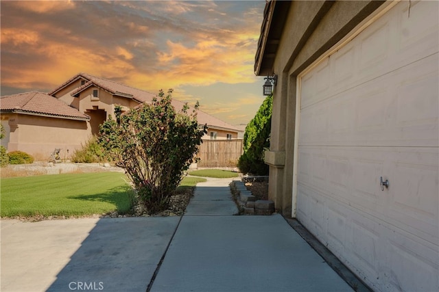 exterior space featuring a garage and a yard