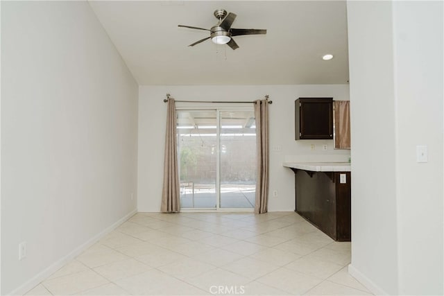 tiled empty room with ceiling fan