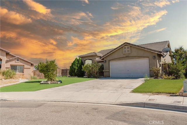 view of front of home featuring a garage and a yard