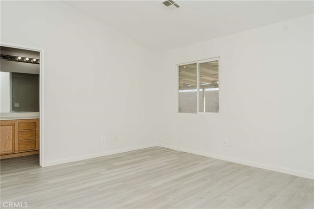 spare room featuring light wood-type flooring