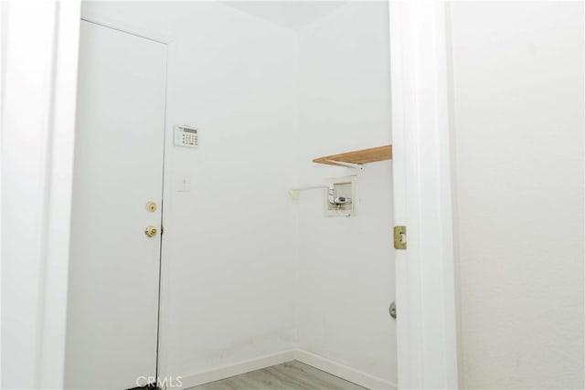 clothes washing area with washer hookup and light hardwood / wood-style flooring