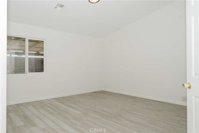 spare room featuring light hardwood / wood-style flooring