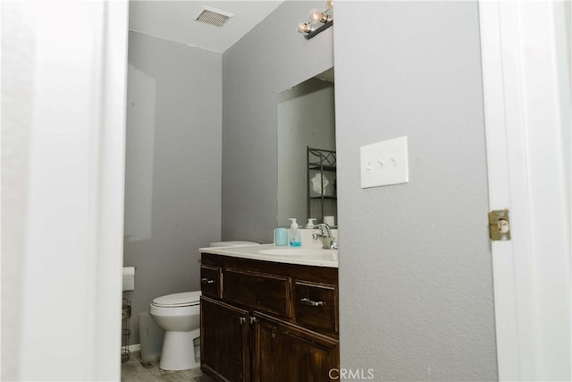 bathroom with toilet and vanity